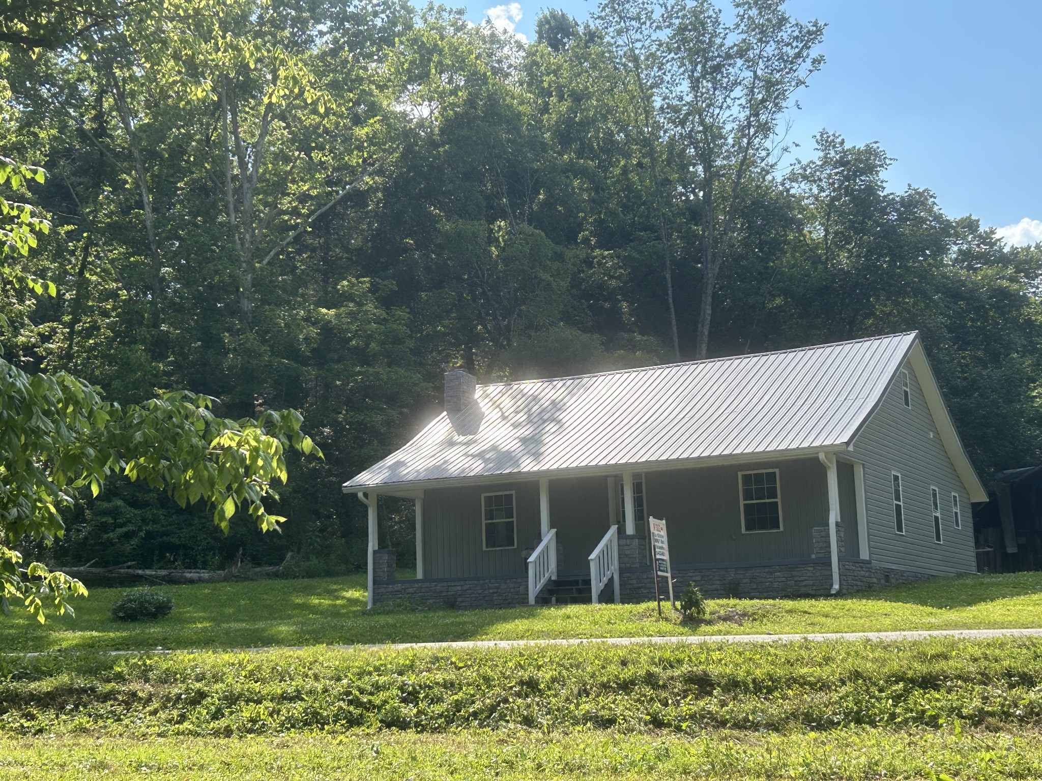 a view of a yard in front view of a house