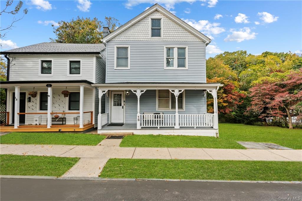 View of front facade featuring a front lawn and a porch