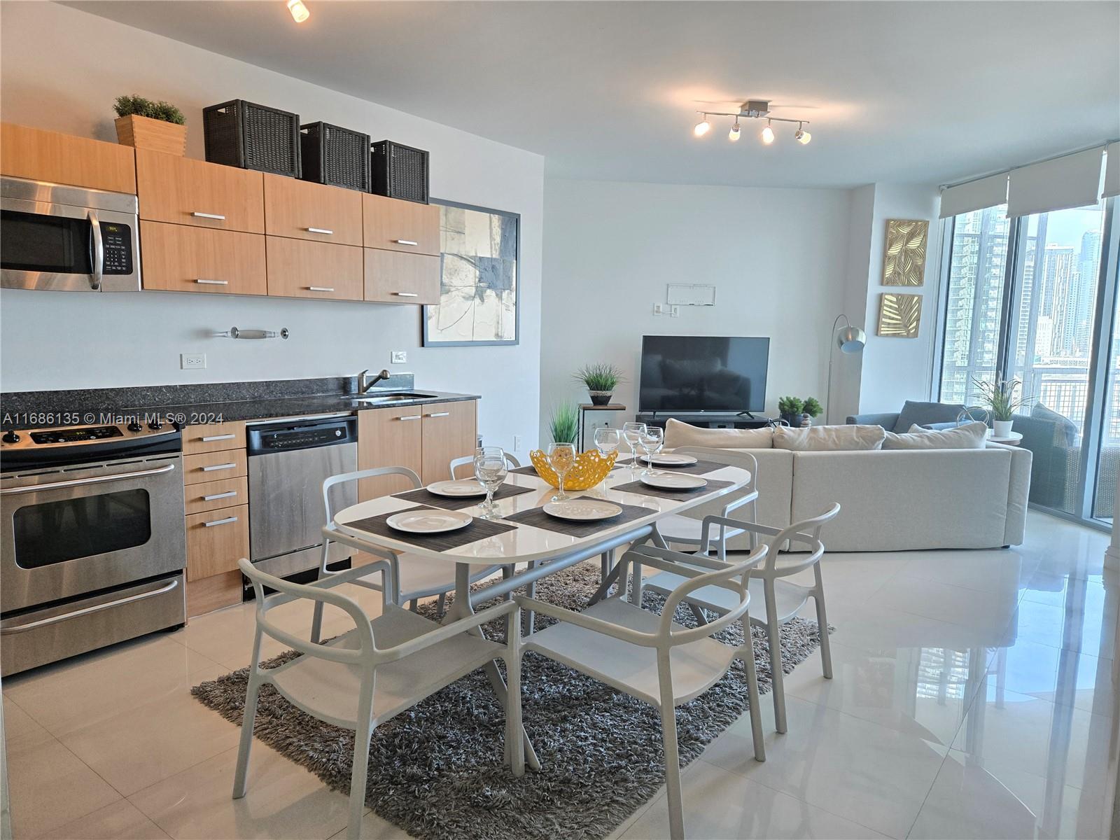 a view of a dining room with furniture and a kitchen