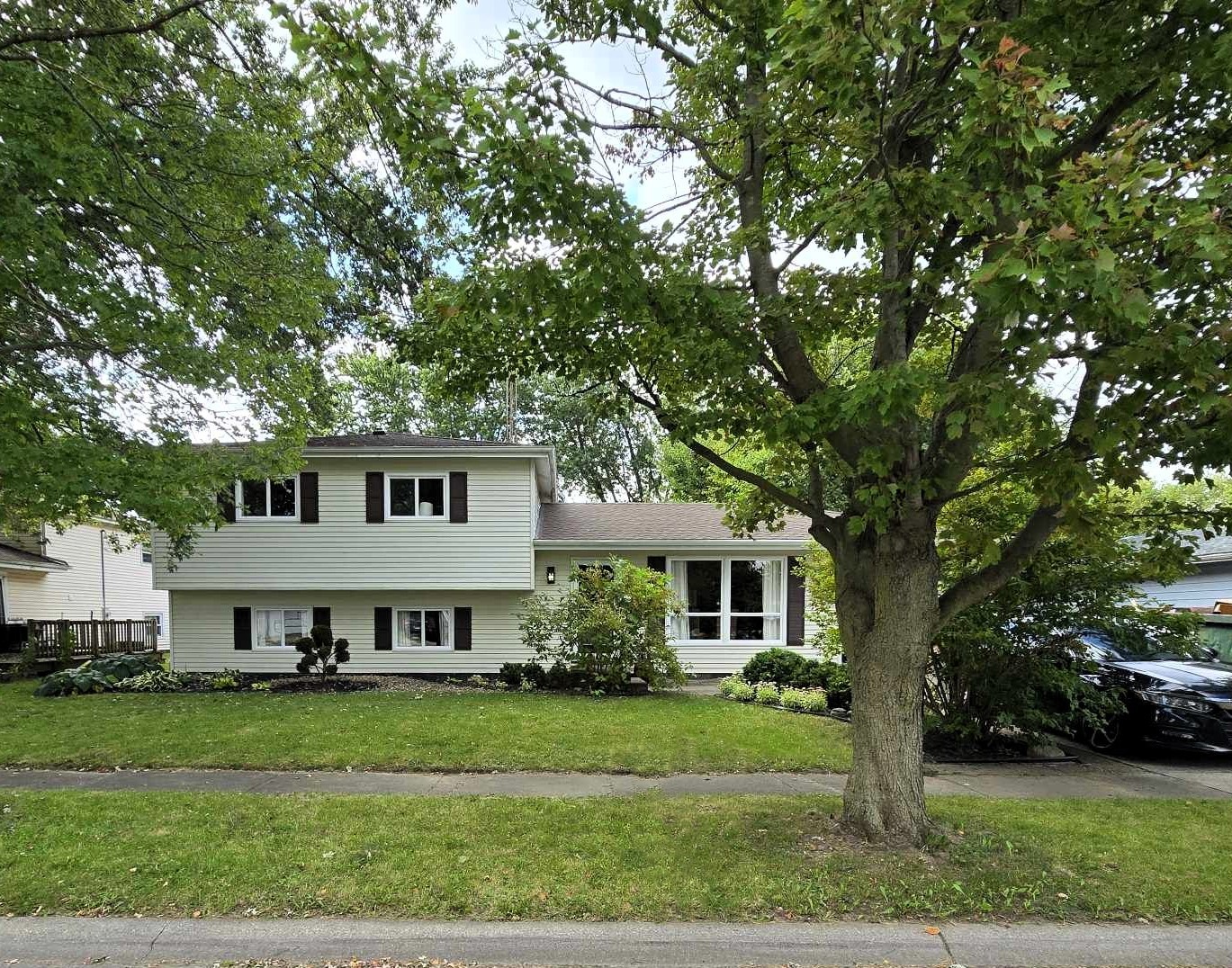 a front view of a house with a garden