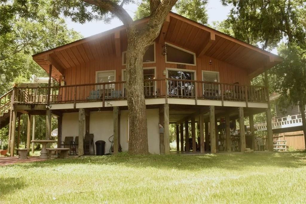 a view of a house with backyard and sitting area