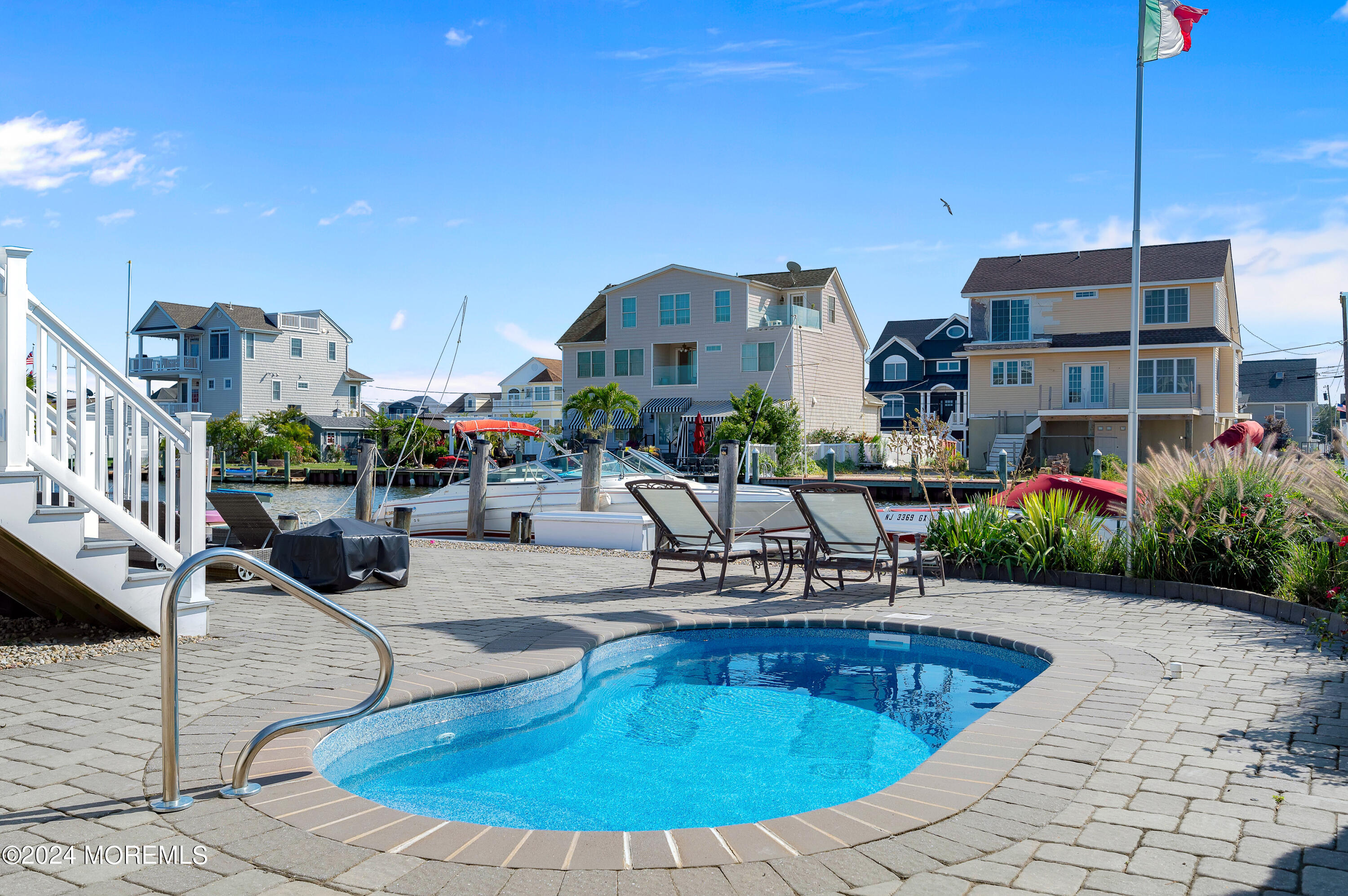 a view of a swimming pool with outdoor seating