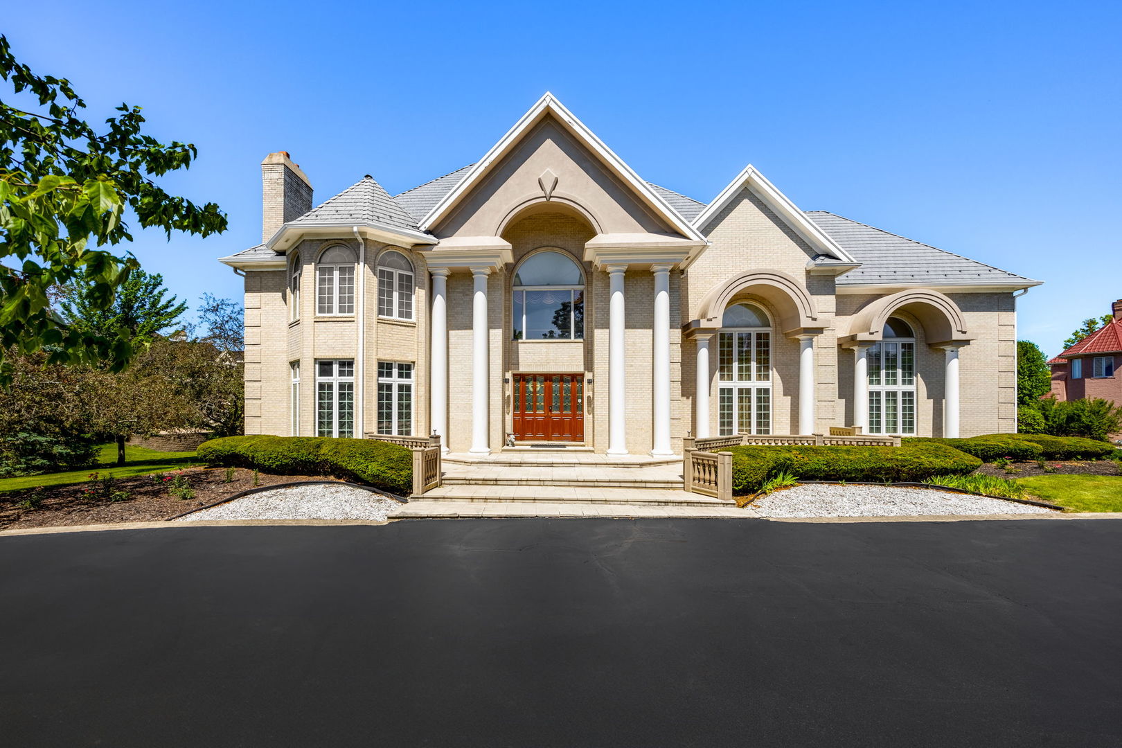 a front view of a house with a garden