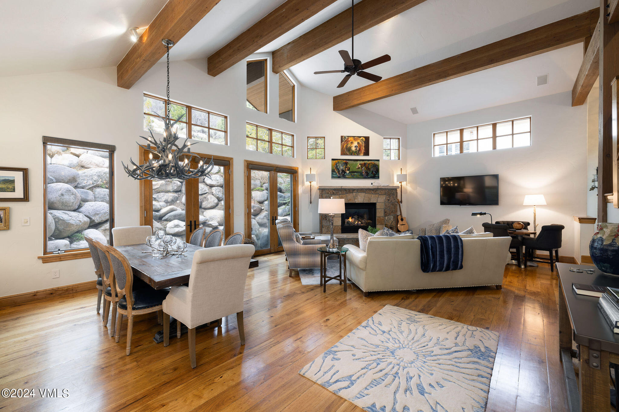 a living room with fireplace furniture and a wooden floor