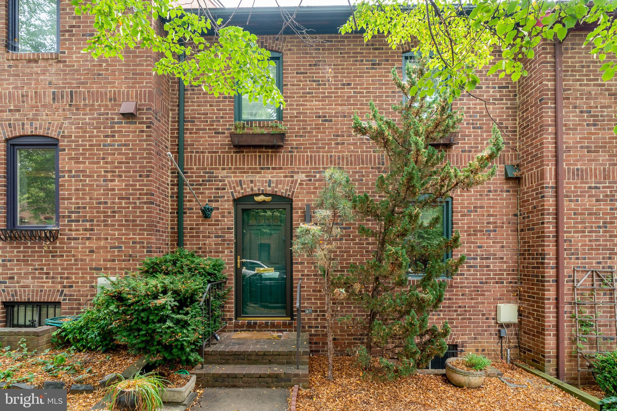 a front view of a house with plants