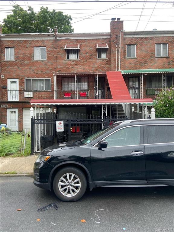 a car parked in front of a brick house