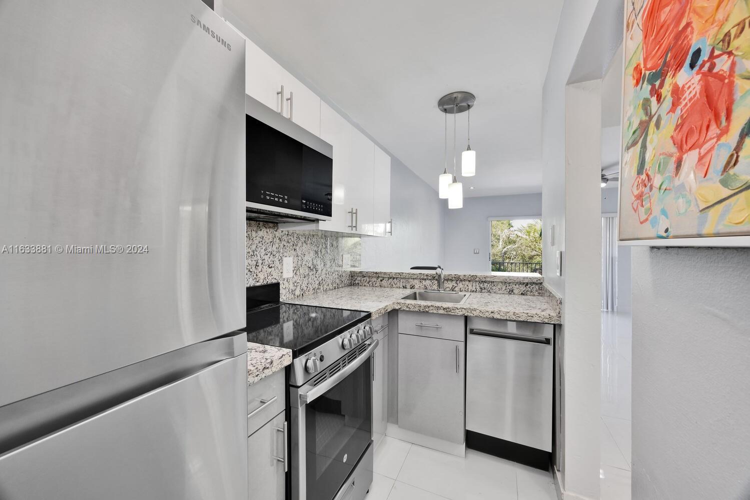 a kitchen with a sink stove and microwave