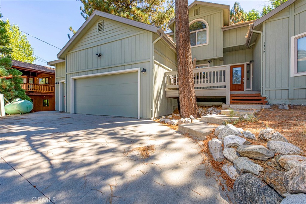 a view of a house with a yard and wooden fence