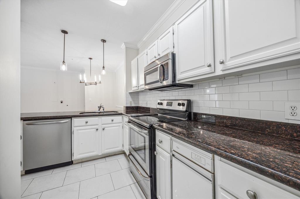 a kitchen with stainless steel appliances granite countertop a sink a stove and cabinets