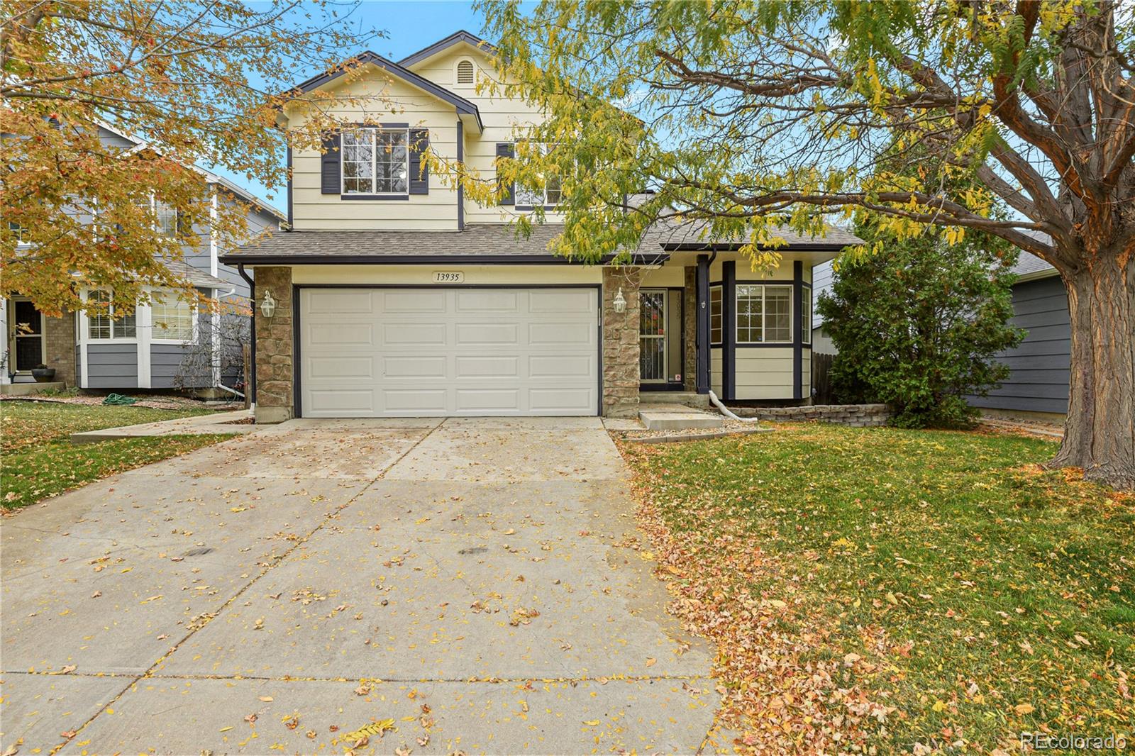 a front view of a house with a yard and garage