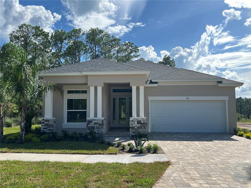 a front view of a house with garden