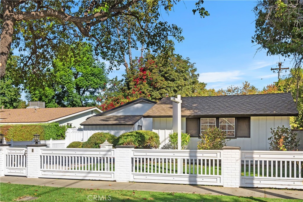 a view of a house with a deck and a yard