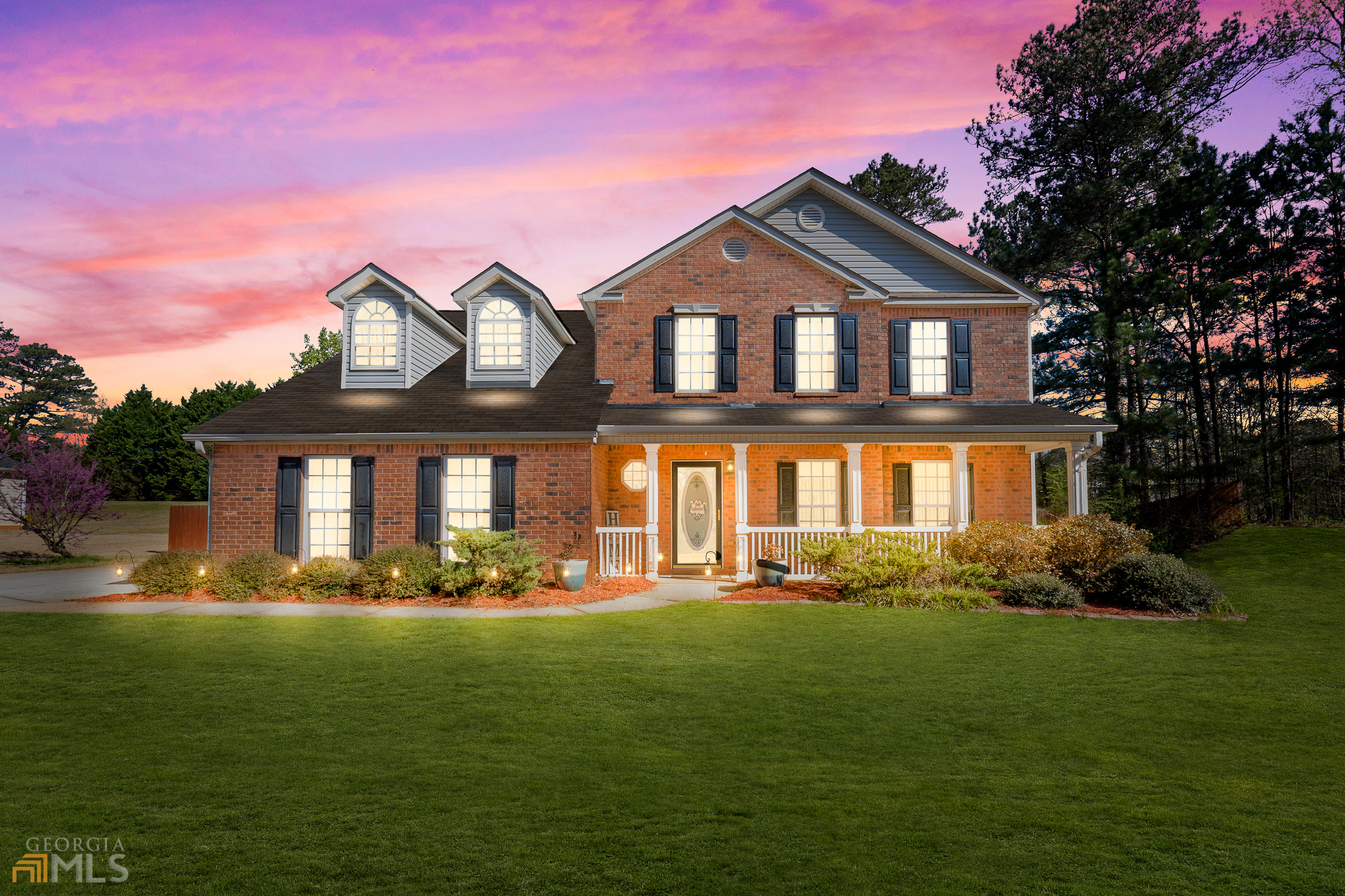 a front view of a house with a big yard