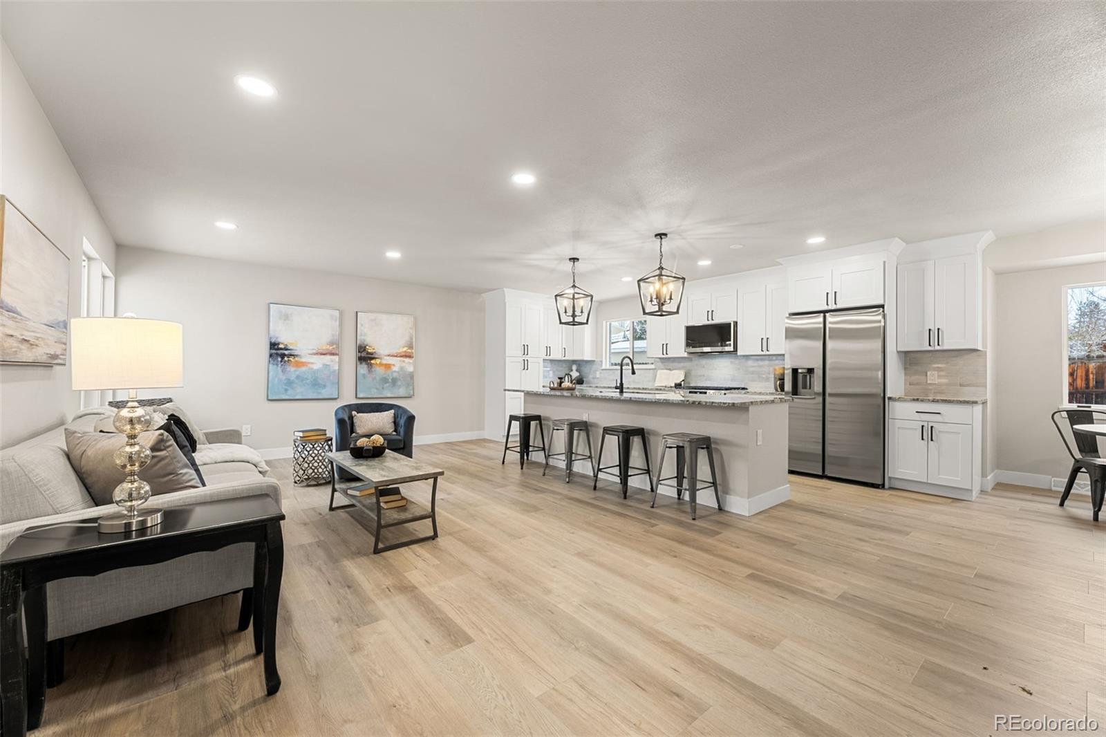 a living room with stainless steel appliances kitchen island granite countertop furniture and a kitchen view