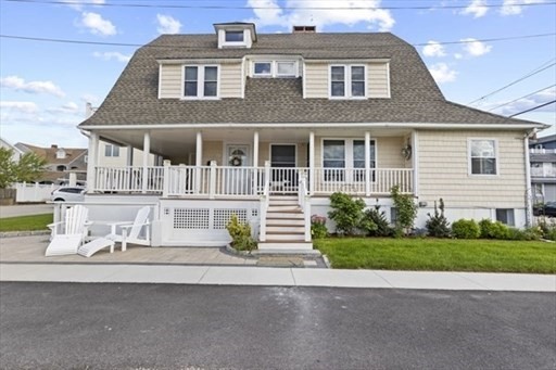 a front view of a house with a garden and plants