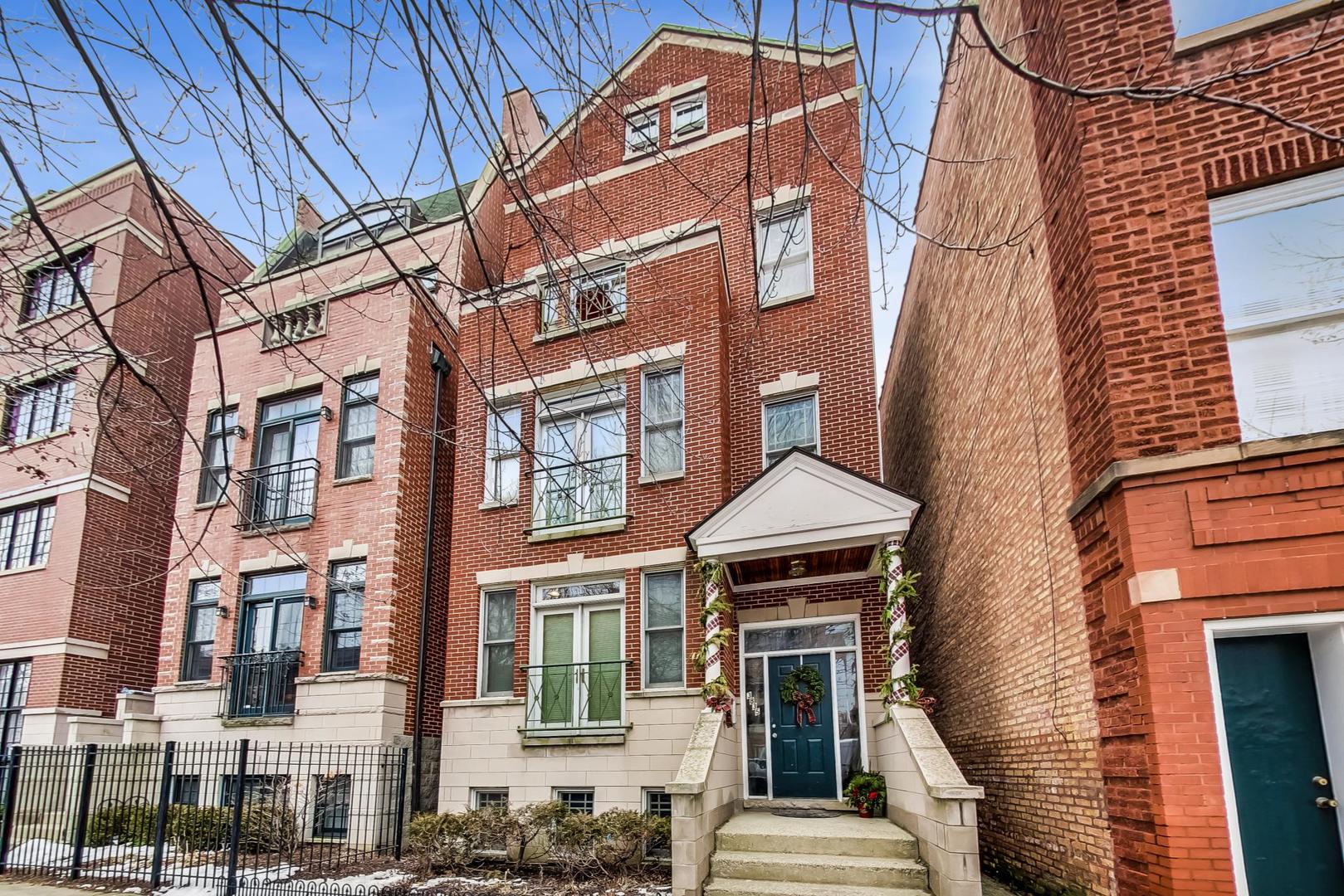 a front view of a residential apartment building with a yard