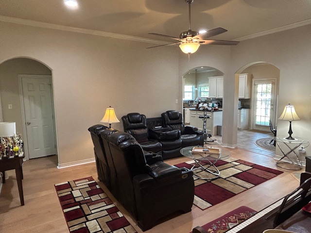 a living room with lots of furniture and chandelier