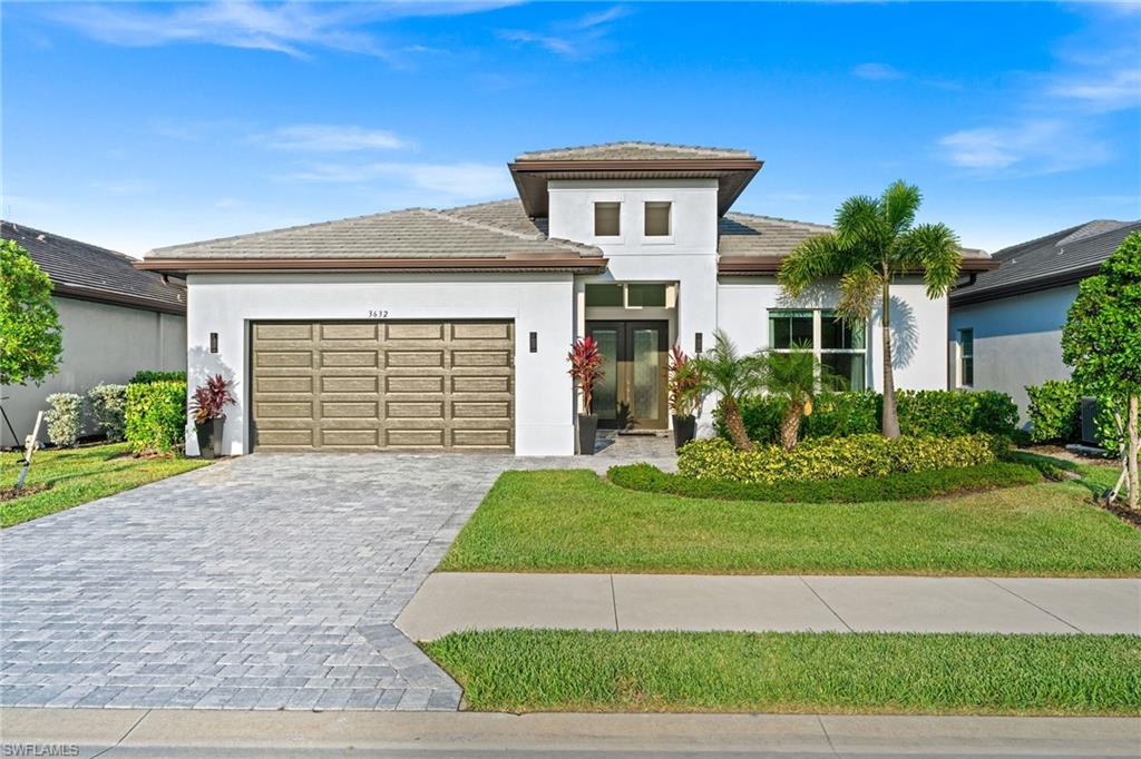 a front view of a house with a yard and garage