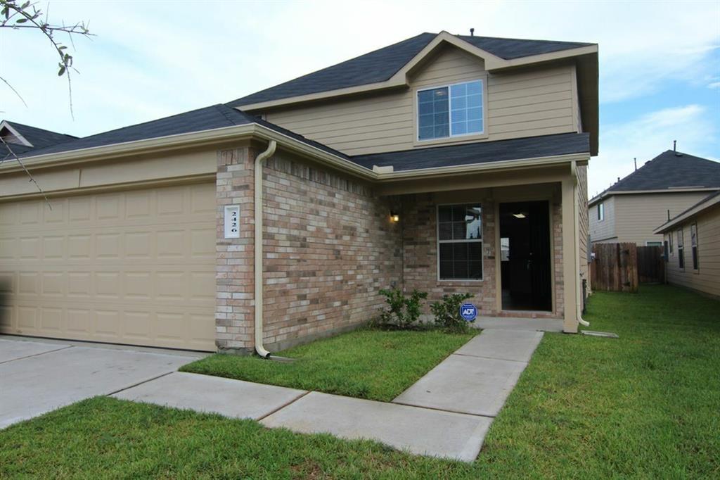 a front view of a house with a garden and plants