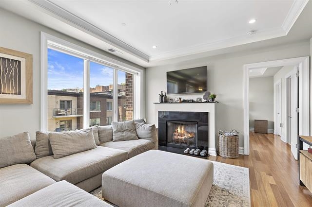 a living room with furniture flat screen tv and a fireplace