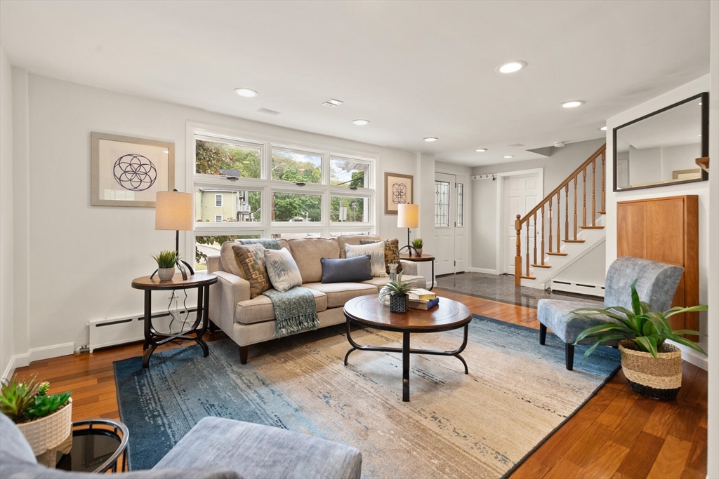 a living room with furniture potted plant and window