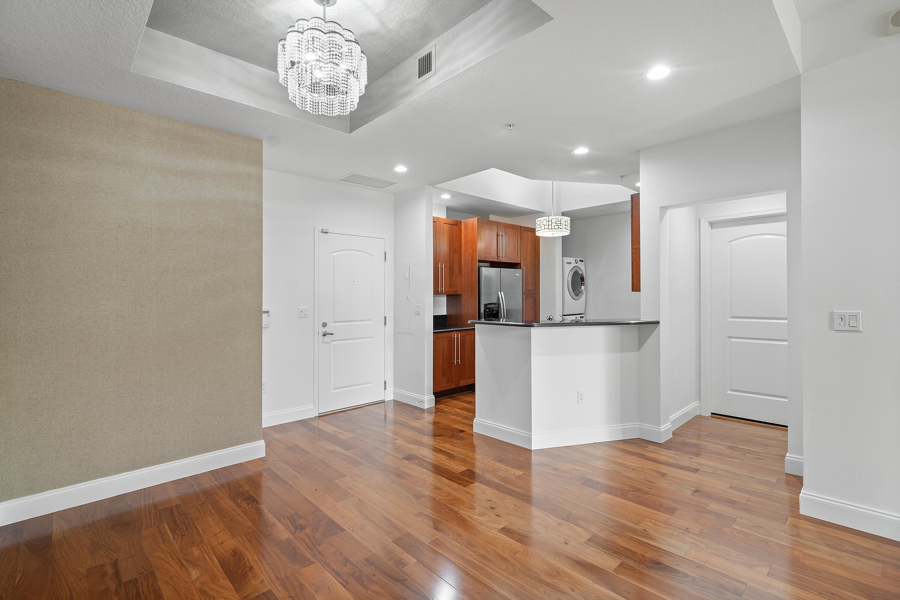 a view of a hallway with wooden floor