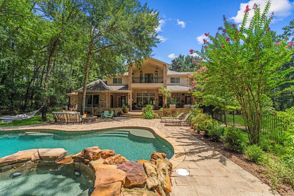 a house view with swimming pool and garden space