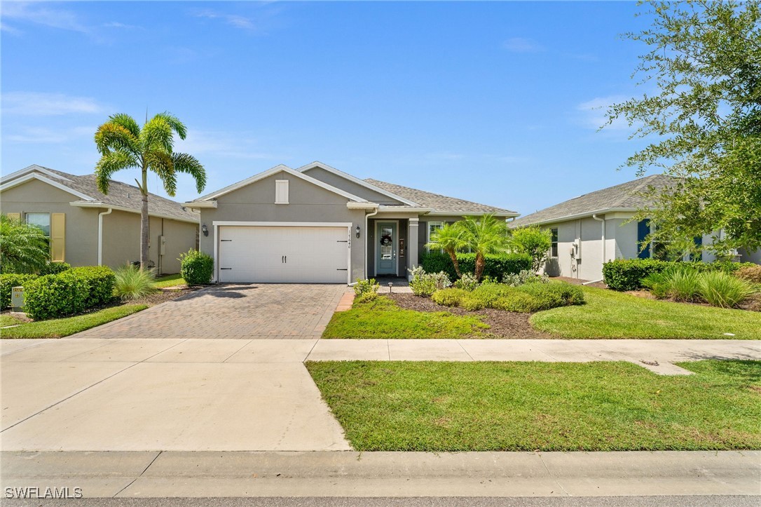 a front view of a house with a yard and garage