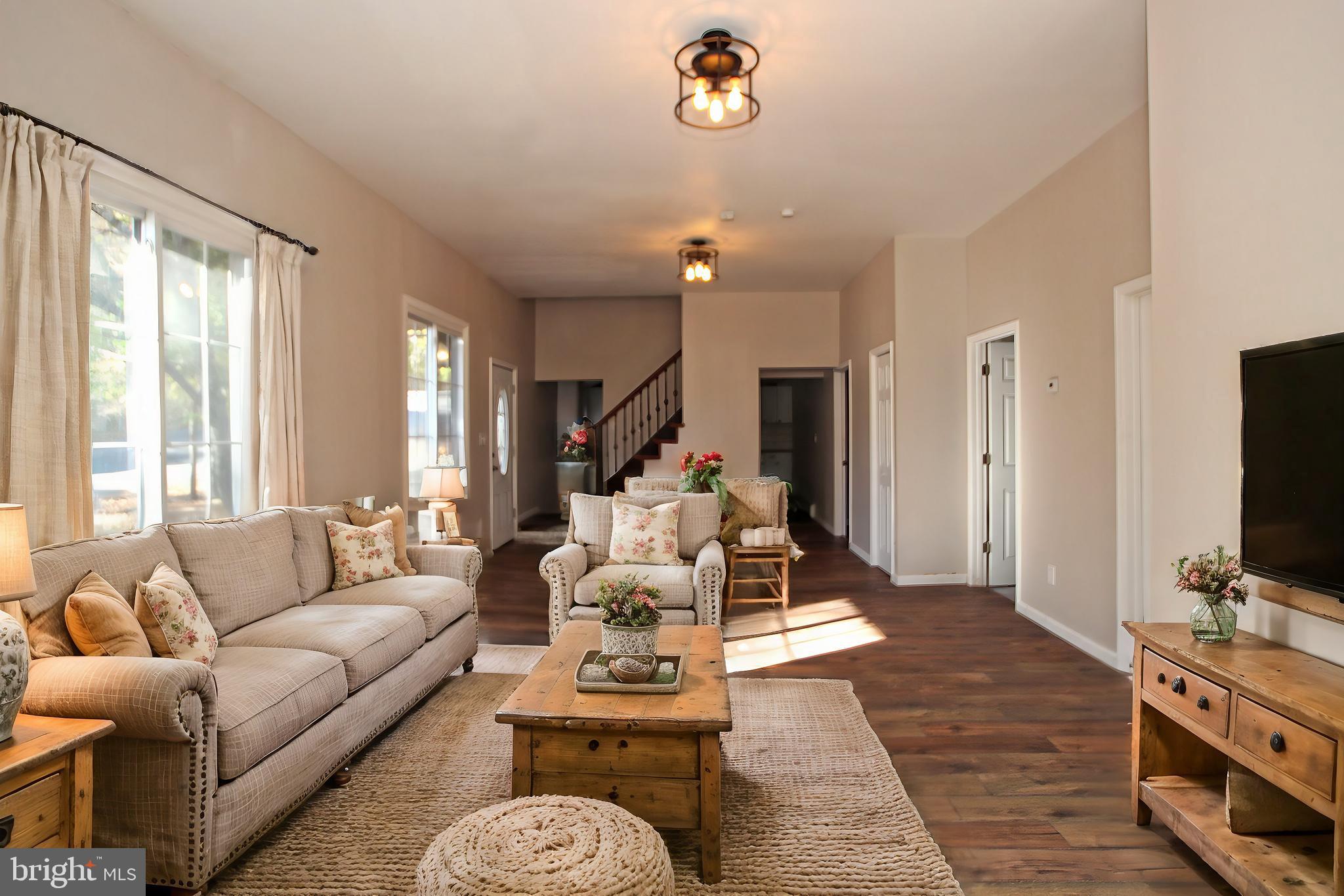 a living room with furniture fireplace and flat screen tv