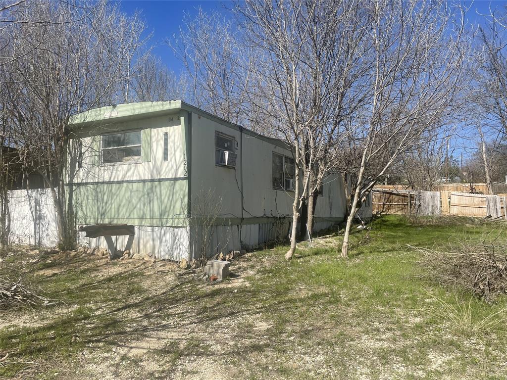 a backyard of a house with table and chairs