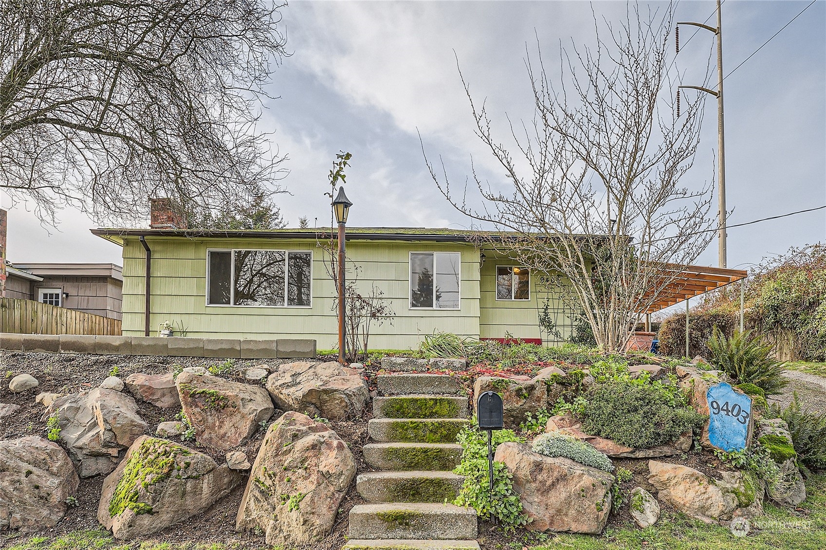 a front view of a house with a garden