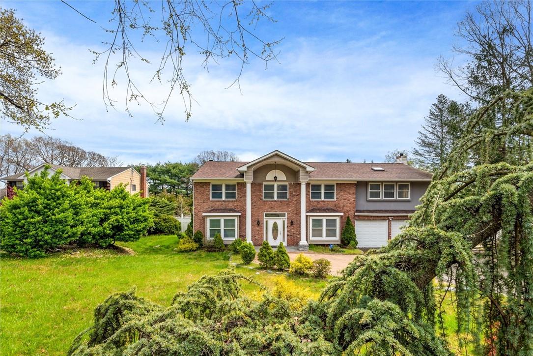 a front view of a house with a big yard