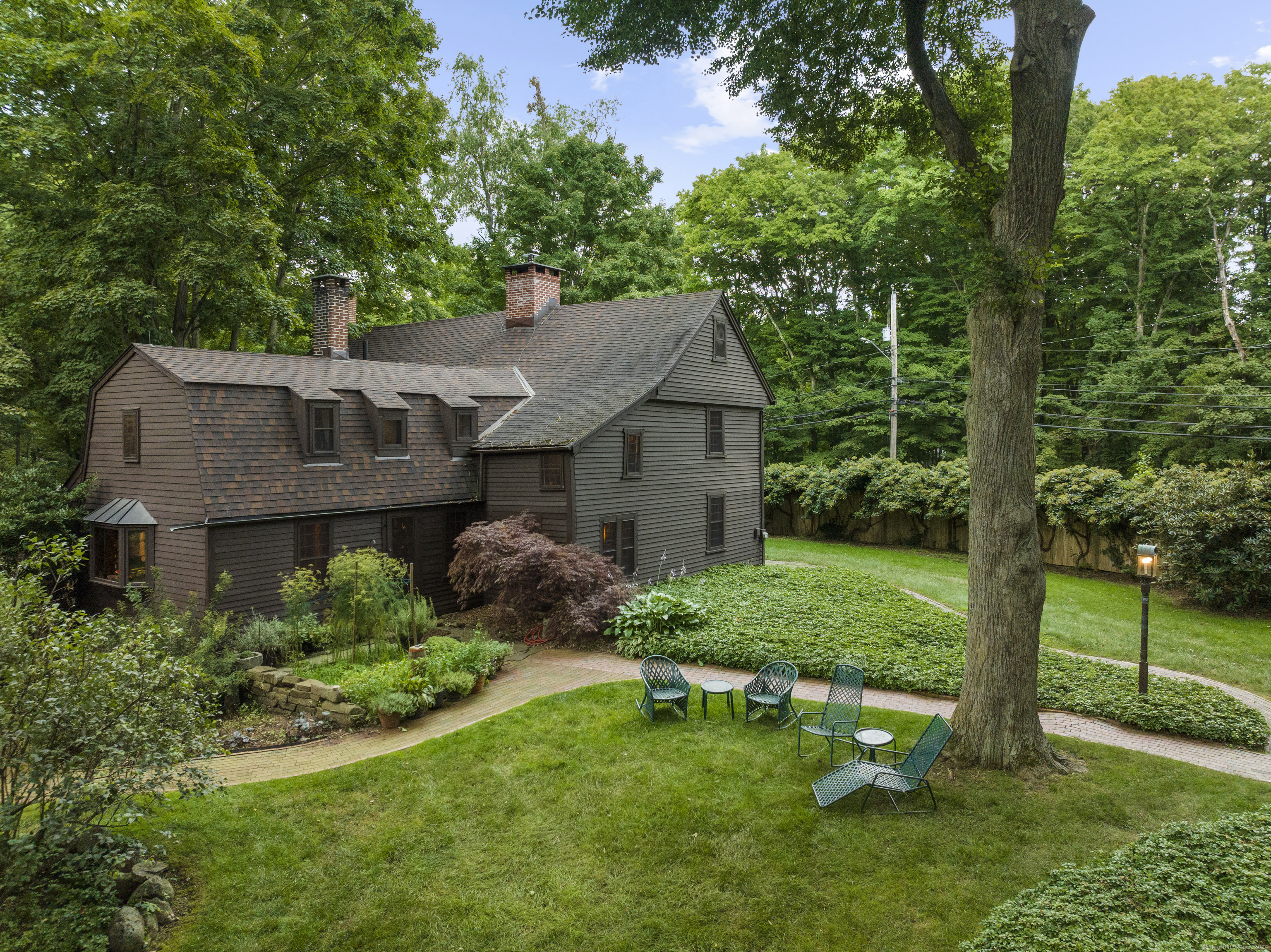 a aerial view of a house with a yard table and chairs