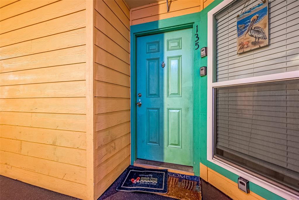 a view of a door and wooden floor