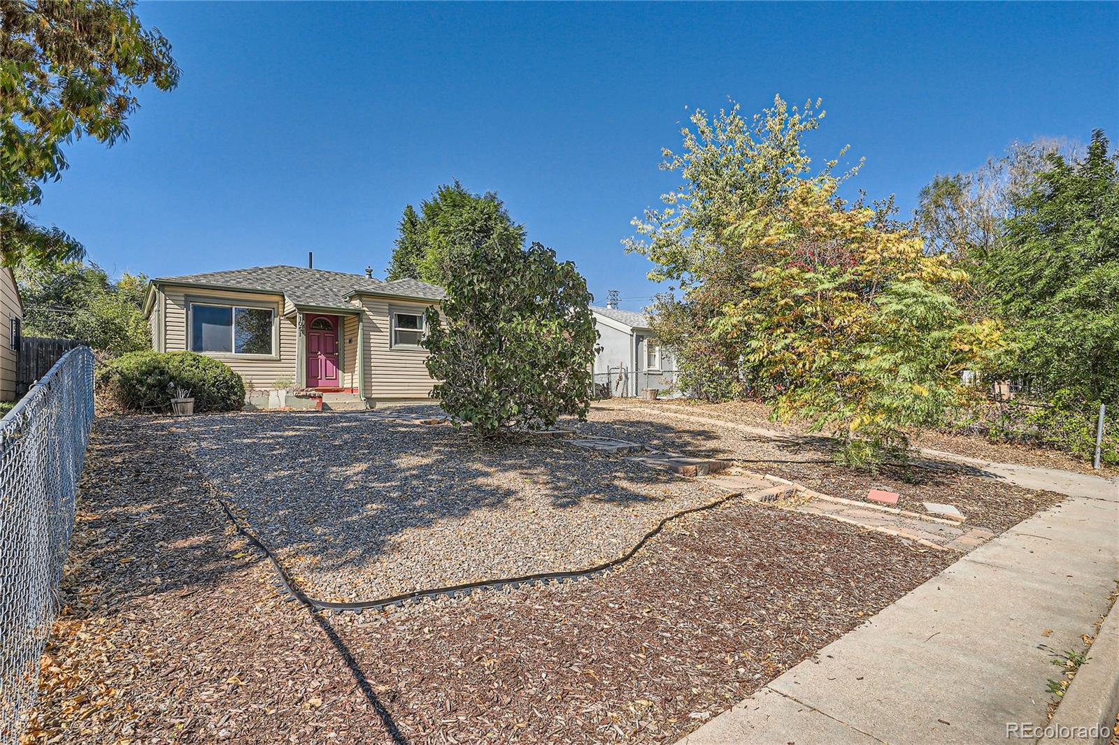 a view of a yard with a house and a tree