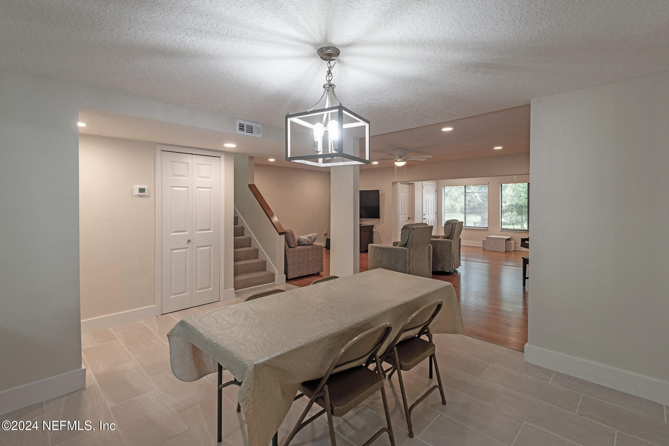 a view of a dining room with furniture and a chandelier