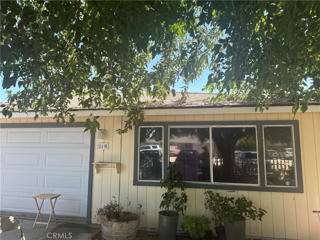 a view of a house with a tree