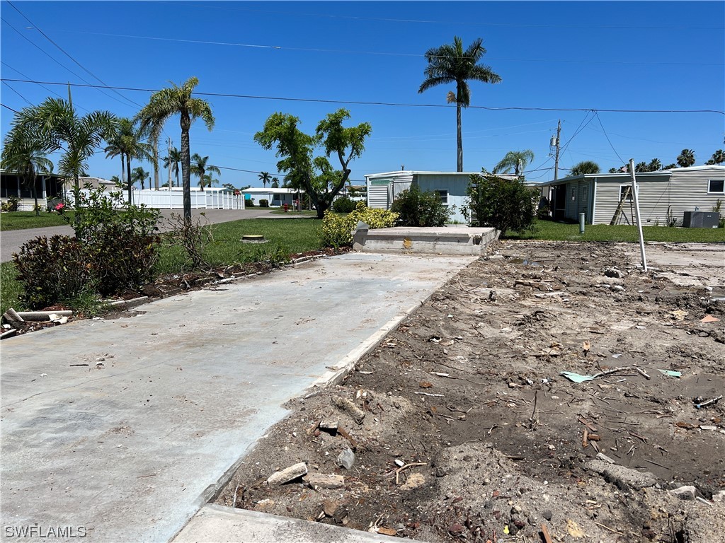 a view of a yard with a table and chairs