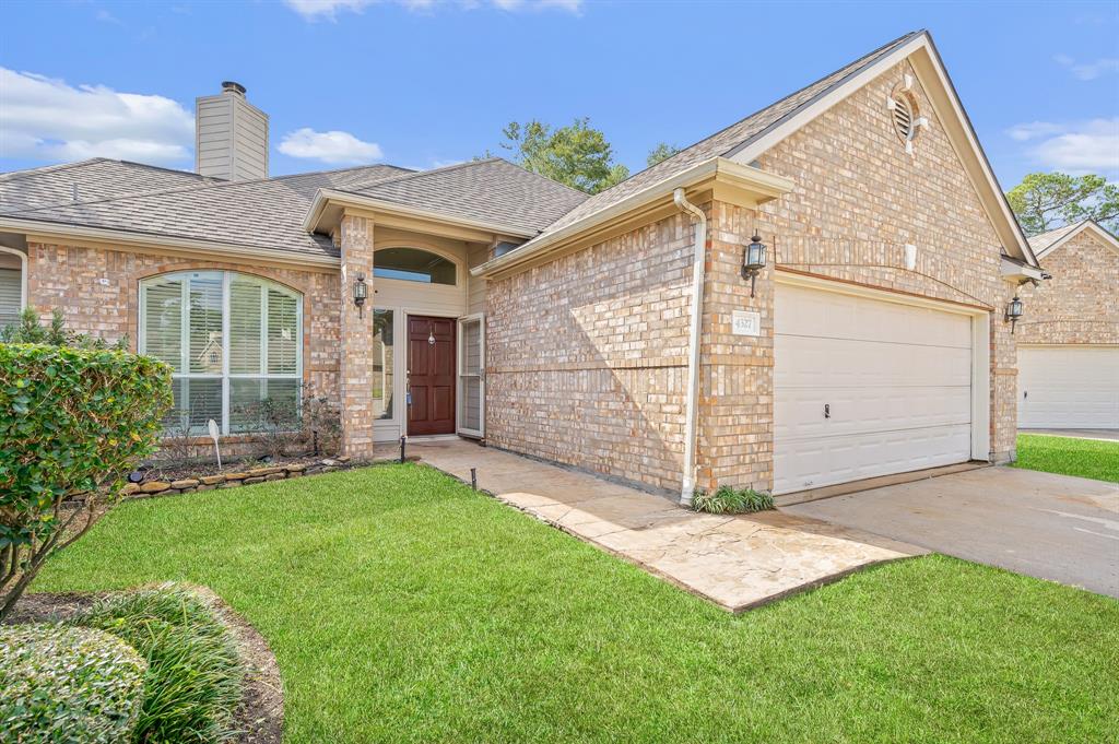 a view of a house with a yard and garage