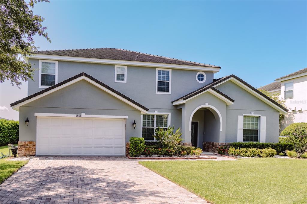 a front view of a house with a yard and garage