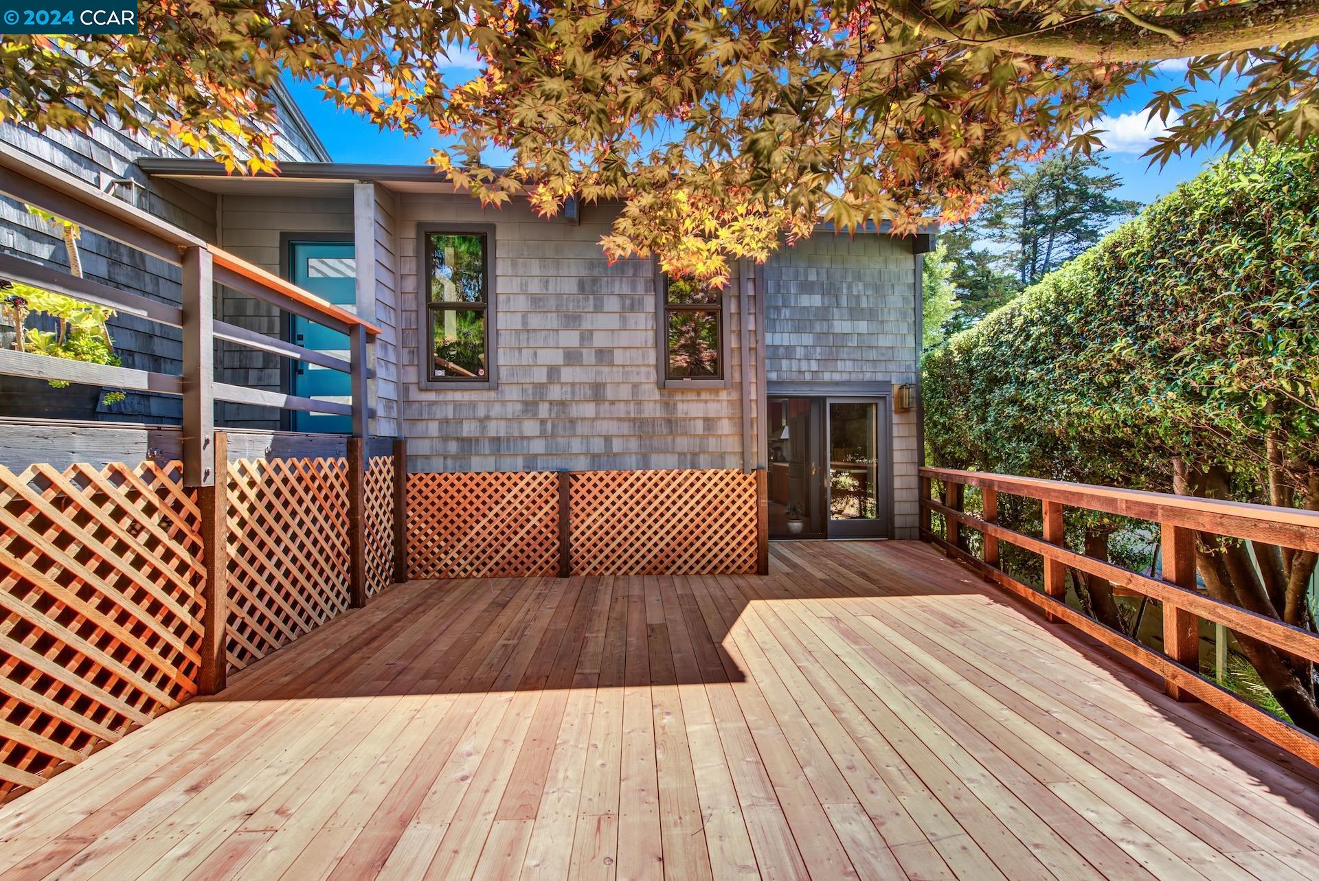 a view of a roof deck with wooden floor and fence