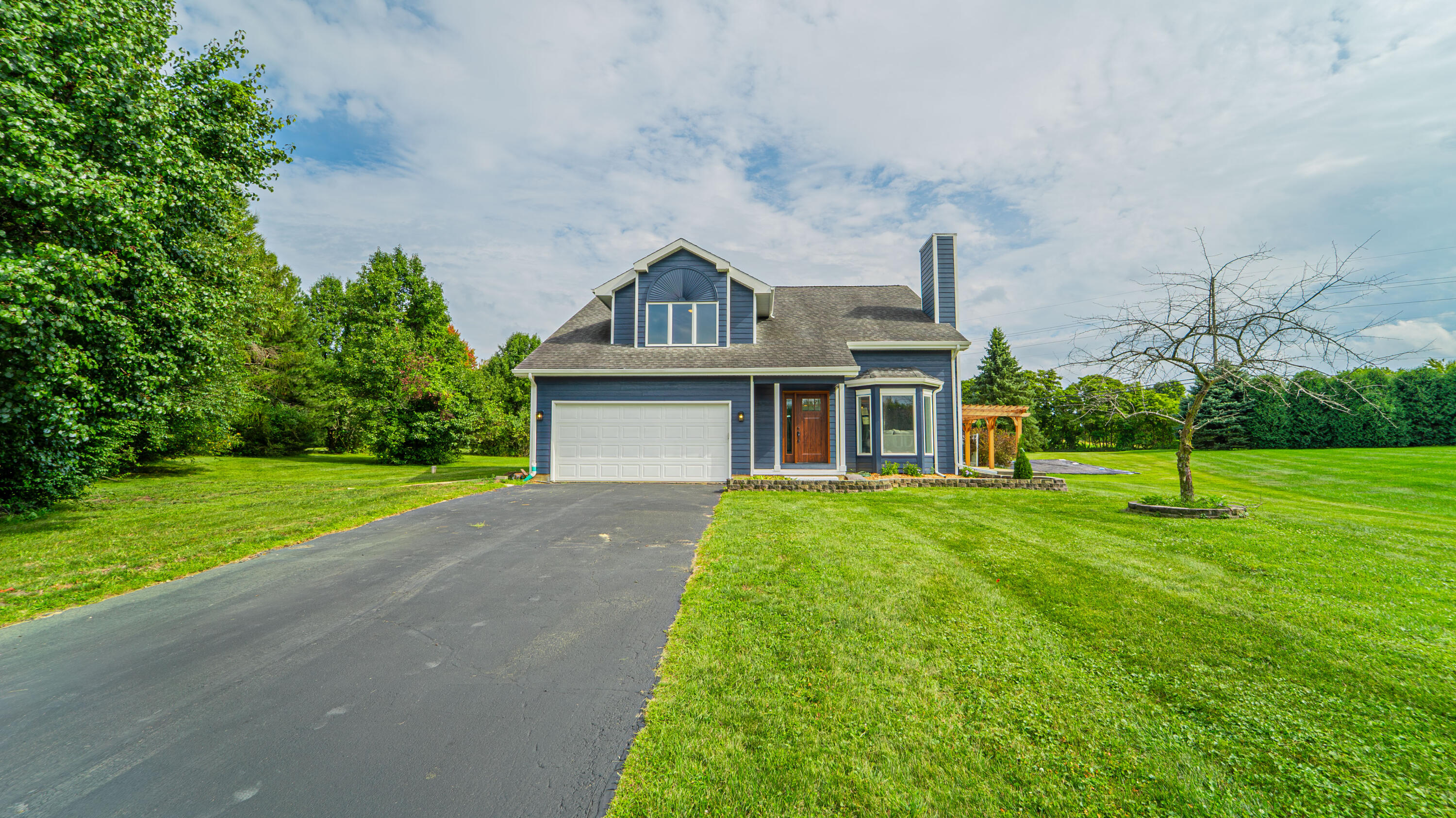 a front view of a house with a yard