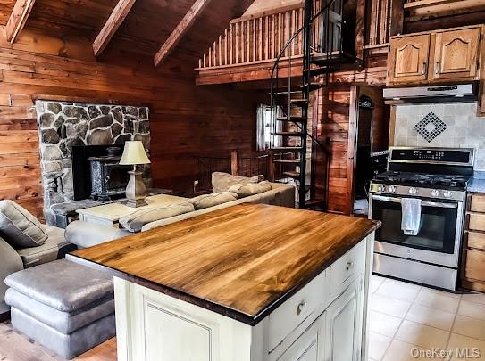 a kitchen with stainless steel appliances kitchen island granite countertop a stove and cabinets