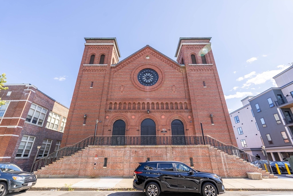 a front view of a building with parking space