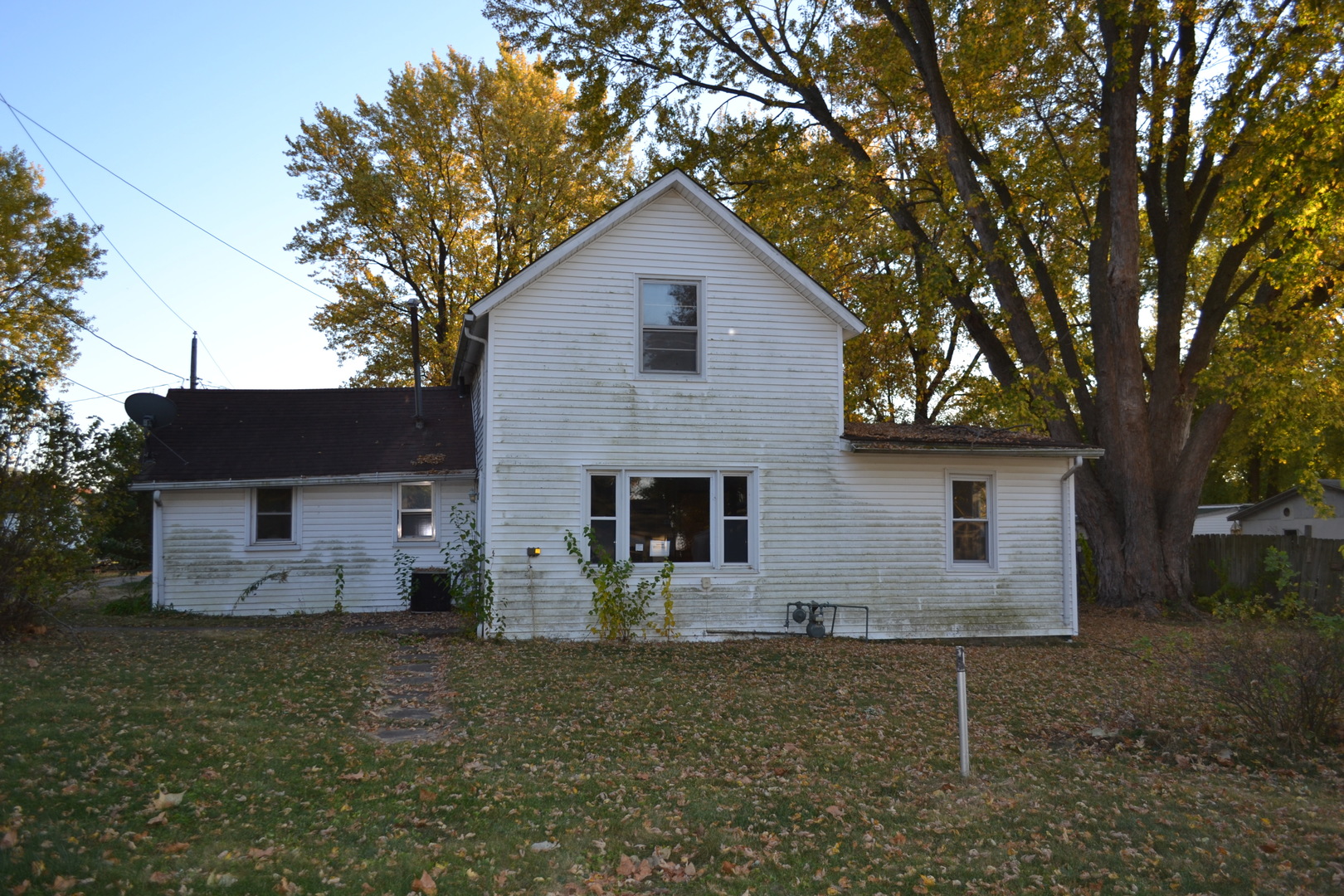 a front view of house with yard and trees