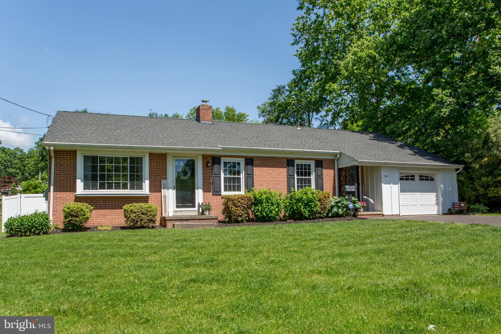 a front view of a house with a yard and porch