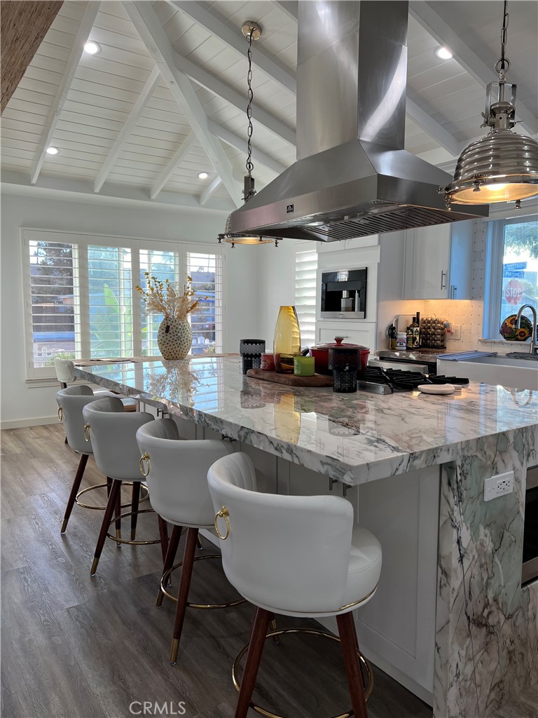 a kitchen with sink and chairs