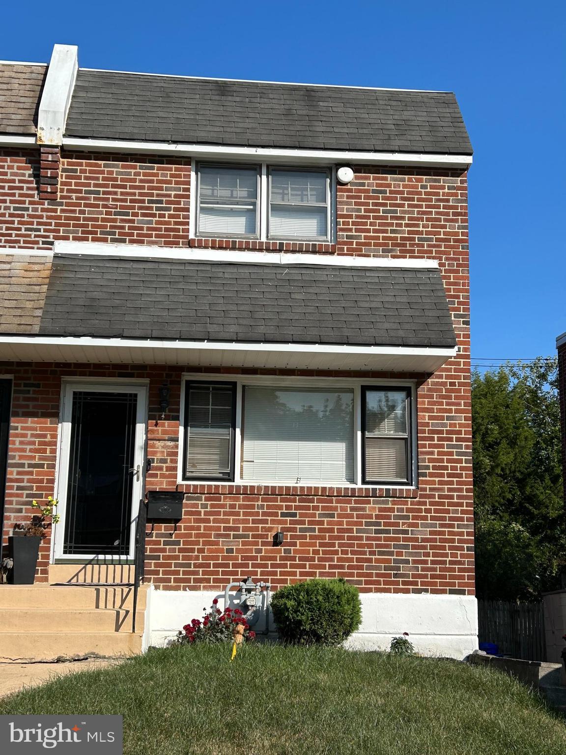 a view of a house with brick walls