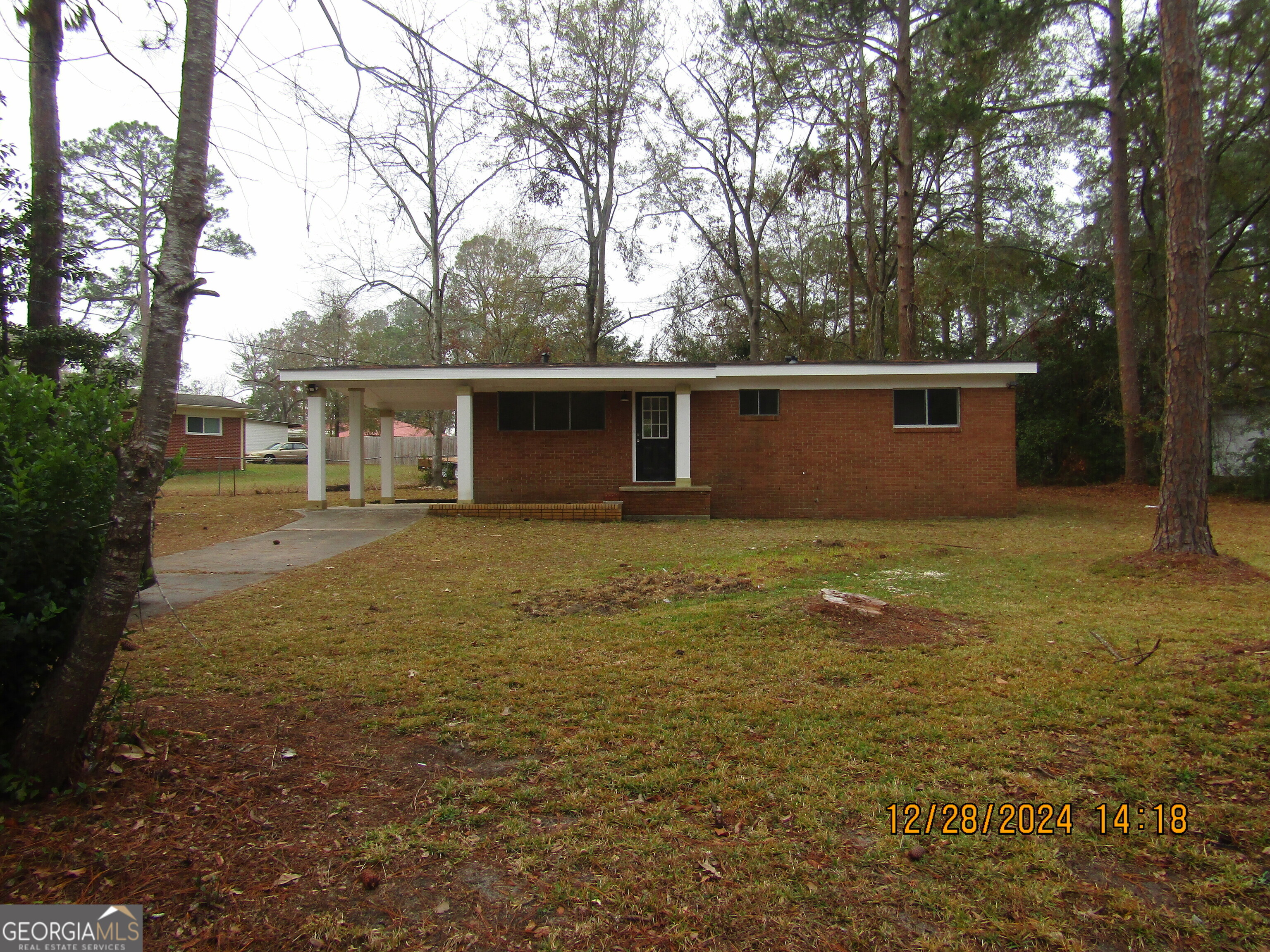 a view of a house with backyard and tree