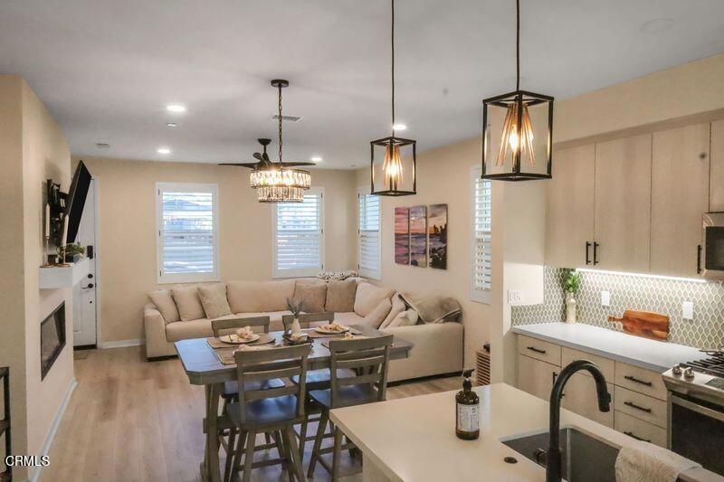 a living room with furniture chandelier and fireplace